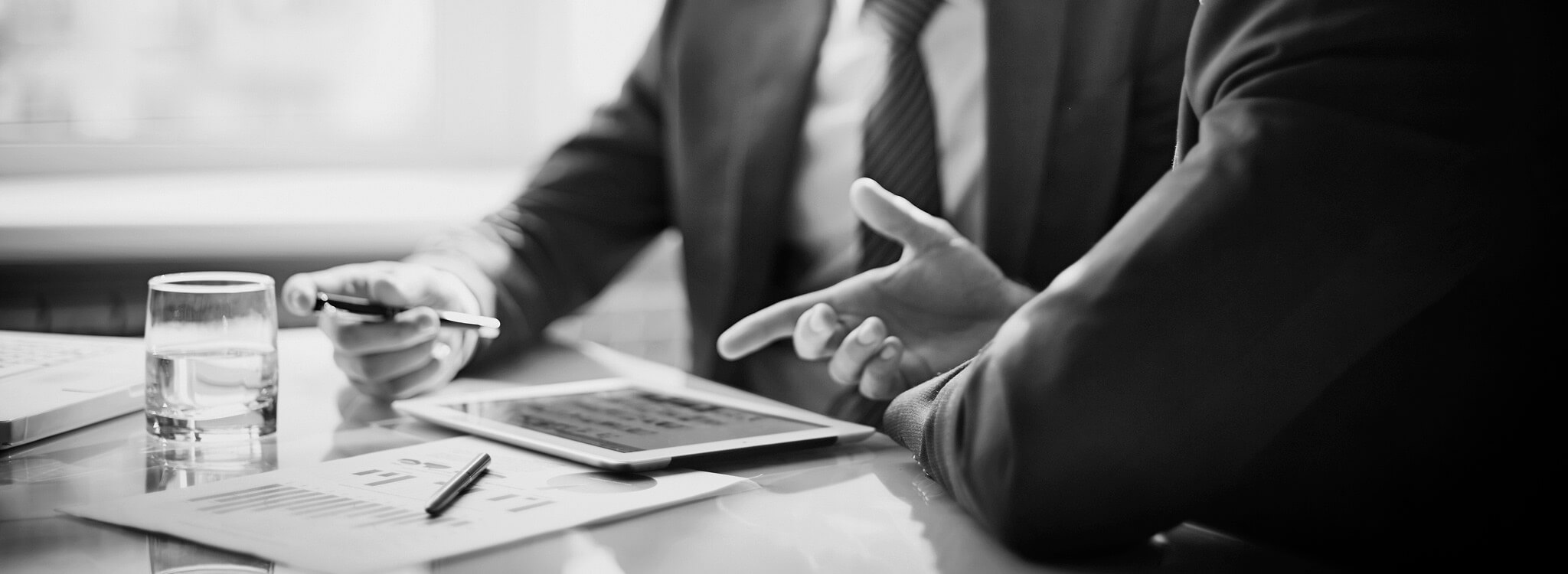 A black and white photo of a businessman sitting at a table